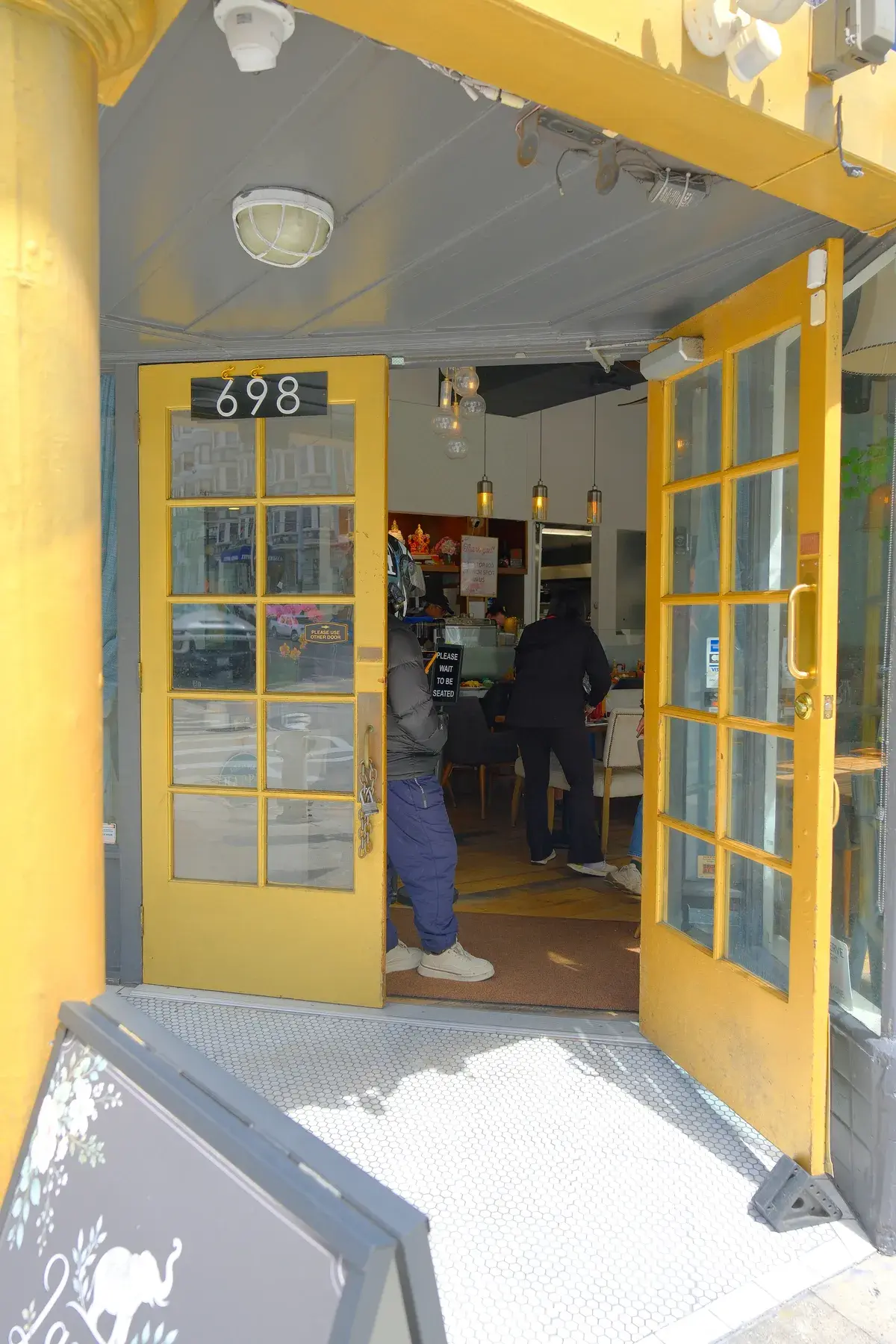 The open yellow doorway at 698 Post Street