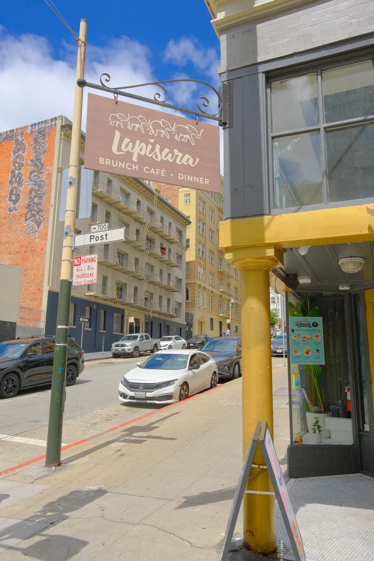 The corner of Post Street with the Lapisara sign and yellow storefront