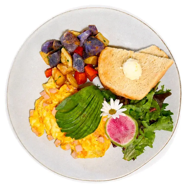 Scrambled eggs with avocado, breakfast potatoes and toast